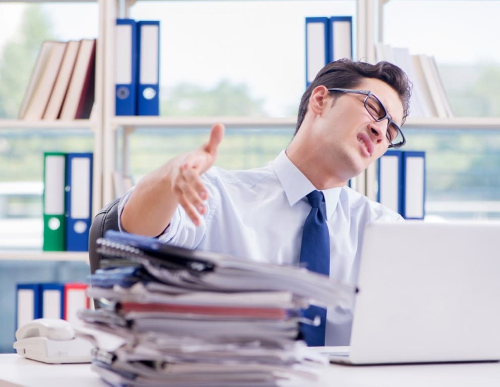 male working in a cluttered office
